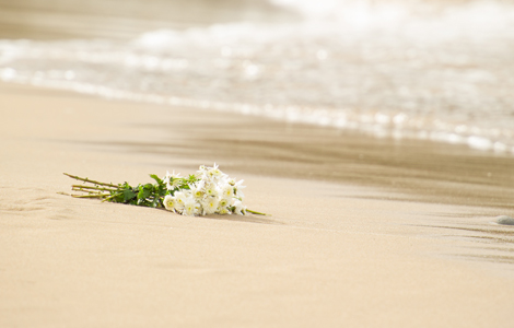 Afscheid bloemen op het strand